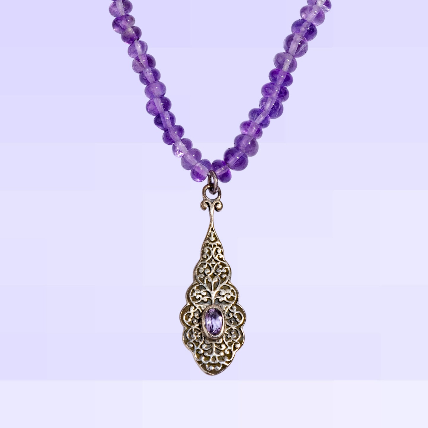 Necklace with amethyst gemstone and a silver pendant 