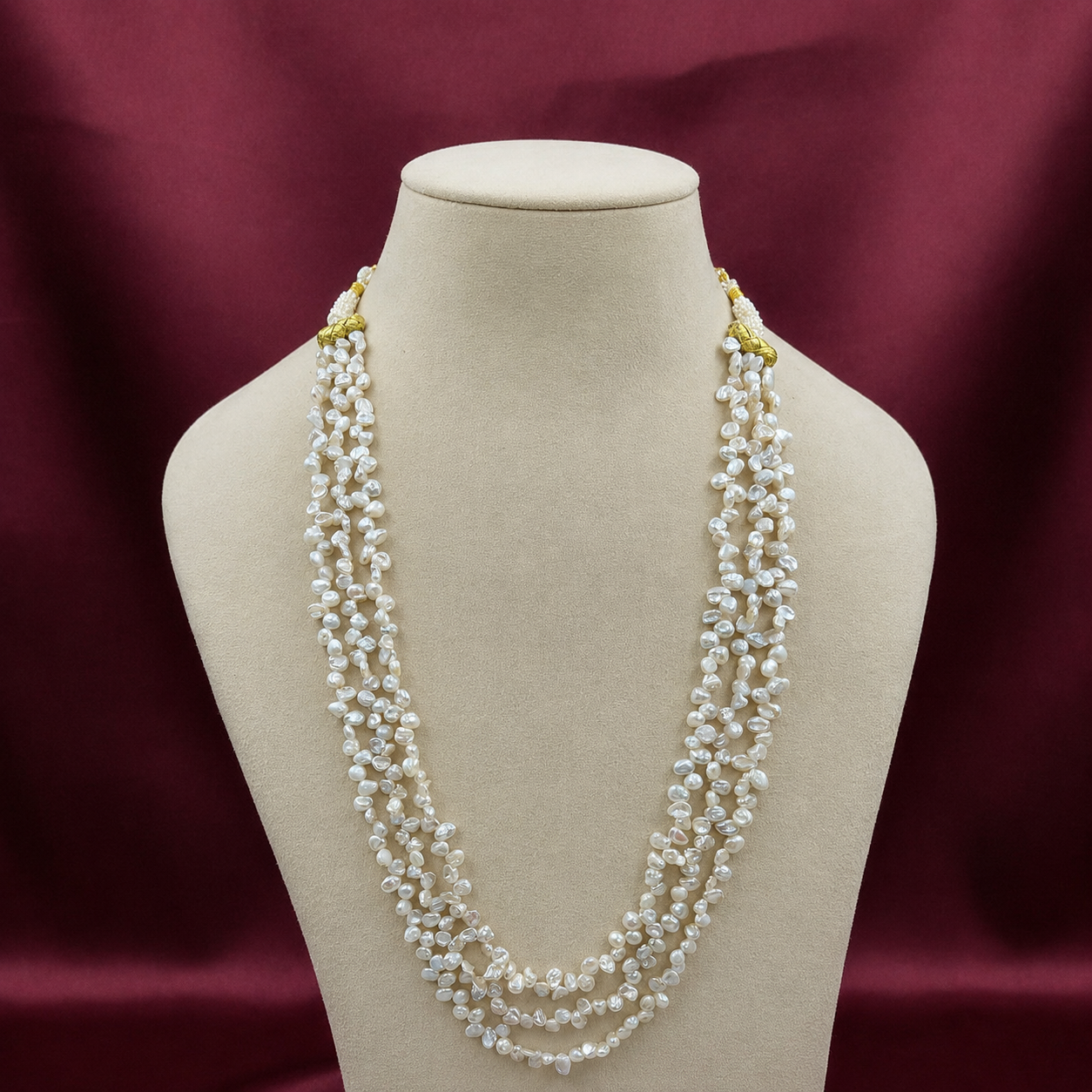 Elara 3-Line Keshi Freshwater Pearl Necklace displayed on a jewellery bust, showcasing three cascading strands of irregular keshi freshwater pearls.