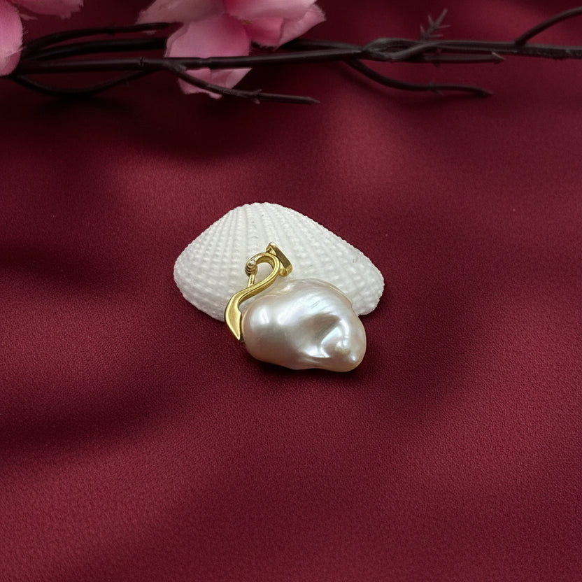 Celeste Swan Baroque Pearl Pendant handcrafted with a genuine freshwater baroque pearl and sterling silver swan bail.