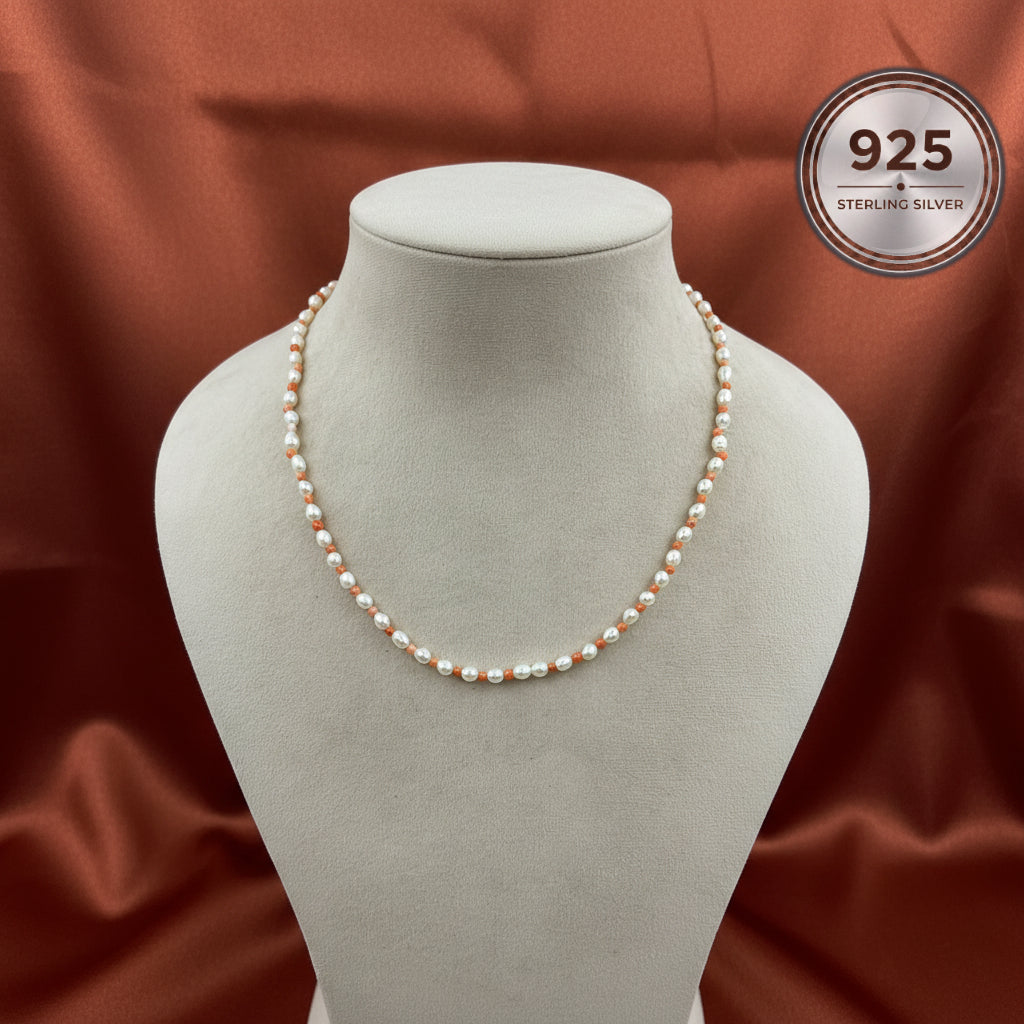 Coraline Freshwater Pearl Necklace displayed on a jewellery bust, featuring genuine freshwater pearls and natural coral beads.