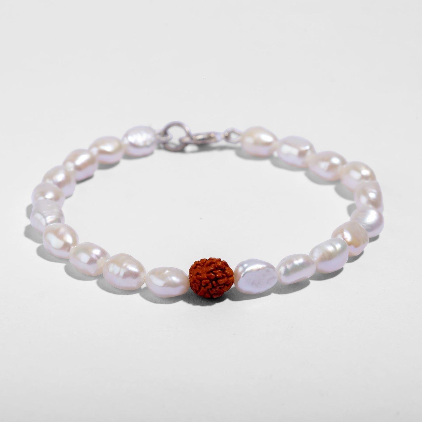 Handcrafted freshwater pearl bracelet featuring a genuine Indonesian Rudraksha bead.