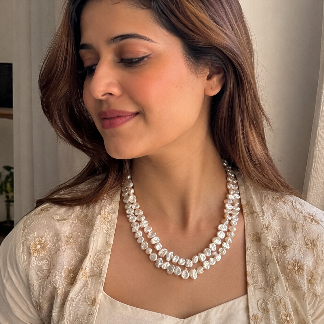 Model wearing the Elara Keshi Pearl Necklace handcrafted with genuine freshwater keshi pearls in a chunky double-strand design.