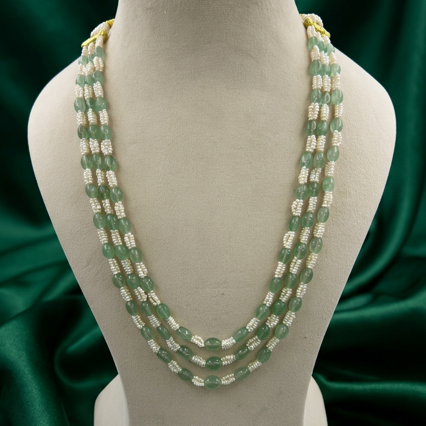 Meera Strawberry Emerald & Freshwater Pearl Necklace displayed on a jewellery bust with genuine Strawberry Emerald gemstones and freshwater seed pearls.
