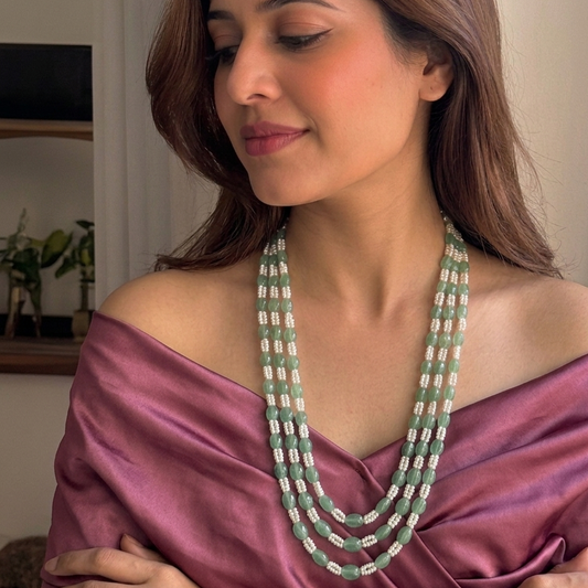 Model wearing the Meera Strawberry Emerald & Freshwater Pearl Necklace featuring genuine Strawberry Emerald gemstones and freshwater rice pearls.